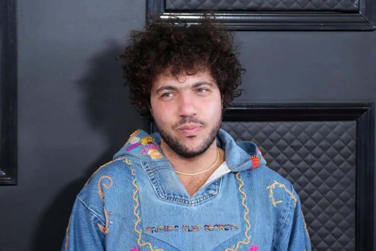 Benny Blanco wearing a denim hoodie with "Friends Keep Secrets" embroidery