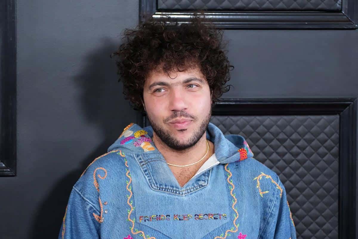 Benny Blanco wearing a denim hoodie with "Friends Keep Secrets" embroidery